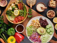 Vegan protein source. Buddha bowl dish, avocado, pepper, tomato, cucumber, red cabbage, chickpea, fresh lettuce salad and walnuts, nuts, beans, . Healthy vegetarian eating, super food. Top view.